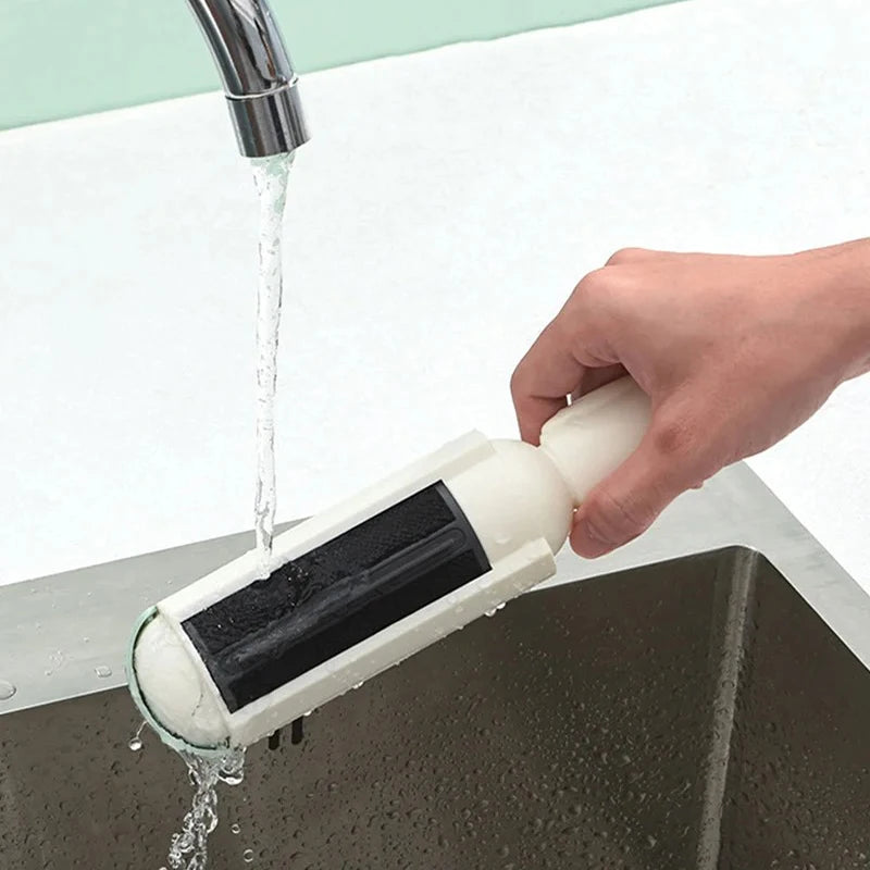 Reusable pet hair remover being cleaned under running water